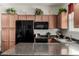 Kitchen with sleek black appliances and granite countertops at 3578 E Walnut Rd, Gilbert, AZ 85298