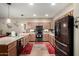 Bright and functional kitchen with wood cabinets, black appliances, and ample counter space at 3578 E Walnut Rd, Gilbert, AZ 85298