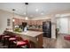 Spacious kitchen with stainless steel appliances, a breakfast bar, and warm pendant lighting at 3578 E Walnut Rd, Gilbert, AZ 85298
