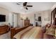 Spacious main bedroom featuring a ceiling fan, carpet floors, and ensuite bathroom access at 3578 E Walnut Rd, Gilbert, AZ 85298