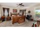 Comfortable main bedroom with a ceiling fan, natural light, and a dedicated desk area at 3578 E Walnut Rd, Gilbert, AZ 85298