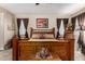 Main bedroom with a large wooden bed, carpet floors, and windows with privacy blinds at 3578 E Walnut Rd, Gilbert, AZ 85298