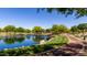 Scenic view of a pond surrounded by lush landscaping and walking trails at 3578 E Walnut Rd, Gilbert, AZ 85298