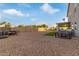 Large backyard featuring gravel landscaping, artificial turf, a patio, and a wooden fence at 38659 N Alamo Ct, San Tan Valley, AZ 85140