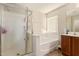 This bathroom features a glass enclosed shower, a tub, and a single sink vanity at 38659 N Alamo Ct, San Tan Valley, AZ 85140