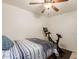 Bedroom featuring a ceiling fan, hardwood floors, a bed, and exercise equipment at 38659 N Alamo Ct, San Tan Valley, AZ 85140