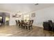 Elegant dining room features a large table with seating for six, neutral tones, and modern light fixture at 38659 N Alamo Ct, San Tan Valley, AZ 85140
