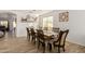 This dining room features hardwood floors and a rustic wood table with a decorative light fixture at 38659 N Alamo Ct, San Tan Valley, AZ 85140