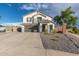 Attractive exterior featuring desert landscaping, a two-car garage, and a well-maintained lawn, creating a welcoming curb appeal at 38659 N Alamo Ct, San Tan Valley, AZ 85140