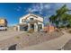 Charming two-story home showcasing neutral stucco, a welcoming front yard, and a spacious driveway leading to the garage at 38659 N Alamo Ct, San Tan Valley, AZ 85140