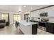 Modern kitchen featuring a large island, stainless steel appliances, and sleek white and black cabinetry at 38659 N Alamo Ct, San Tan Valley, AZ 85140