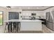 Contemporary kitchen with an expansive island, stainless steel appliances, and stylish two-tone cabinets at 38659 N Alamo Ct, San Tan Valley, AZ 85140
