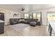 Spacious living room featuring a large sectional sofa, modern ceiling fan, and wood-look flooring at 38659 N Alamo Ct, San Tan Valley, AZ 85140