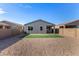 Spacious backyard with gravel and synthetic turf perfect for outdoor activities and low maintenance landscaping at 39959 W Williams Way, Maricopa, AZ 85138