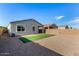 A low maintenance backyard features gravel landscaping and artificial turf at 39959 W Williams Way, Maricopa, AZ 85138
