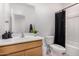 Functional bathroom featuring a single sink vanity and a black curtained shower for basic needs and comfort at 39959 W Williams Way, Maricopa, AZ 85138