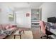 Bright bedroom with natural light, a pink love seat, and desk provides comfort and versatility at 39959 W Williams Way, Maricopa, AZ 85138