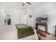 Cozy bedroom featuring a bed, an area rug, a television and convenient access to a walk-in closet at 39959 W Williams Way, Maricopa, AZ 85138