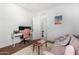 Versatile bedroom design features a large desk area, a comfortable pink love seat, and natural lighting at 39959 W Williams Way, Maricopa, AZ 85138