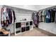 Walk-in closet features built-in shelving and plenty of hanging space for storing clothes and personal items at 39959 W Williams Way, Maricopa, AZ 85138