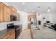Well-equipped kitchen features stainless appliances, granite countertops and ample cabinet storage at 39959 W Williams Way, Maricopa, AZ 85138