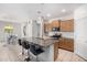Modern kitchen boasts granite countertops, stainless steel appliances, island seating and ample cabinet space at 39959 W Williams Way, Maricopa, AZ 85138