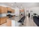 Open kitchen with granite countertops, a central island with seating, and stainless steel appliances at 39959 W Williams Way, Maricopa, AZ 85138