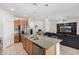 Open-concept kitchen features granite countertops, stainless steel appliances and overlooks the living area at 39959 W Williams Way, Maricopa, AZ 85138