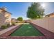 This backyard features decorative stone, lush trees, a unique lawn area, and manicured landscaping at 4055 N Recker Rd # 62, Mesa, AZ 85215