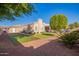 This beautiful backyard features a covered patio and unique lawn area with manicured landscaping at 4055 N Recker Rd # 62, Mesa, AZ 85215