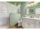 This bathroom has floral wallpaper, a shower, and a white vanity with black hardware at 4055 N Recker Rd # 62, Mesa, AZ 85215
