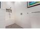 Modern walk-in shower with white textured walls, a built-in bench, and designer fixtures for a spa-like feel at 4055 N Recker Rd # 62, Mesa, AZ 85215