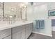 Stylish bathroom featuring double sinks, decorative backsplash, and an enclosed glass shower for a spa-like experience at 4055 N Recker Rd # 62, Mesa, AZ 85215