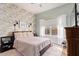 Cozy bedroom with floral wallpaper accent wall, plush bedding, and natural light at 4055 N Recker Rd # 62, Mesa, AZ 85215