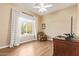 Bright bedroom with a large window, hardwood floors, and a floral-patterned chair at 4055 N Recker Rd # 62, Mesa, AZ 85215