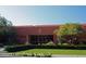 This Red Mountain Ranch community building features large windows, desert landscaping, and green grass at 4055 N Recker Rd # 62, Mesa, AZ 85215
