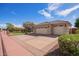 A home with a large three-car garage and manicured landscaping, complete with desert-style greenery at 4055 N Recker Rd # 62, Mesa, AZ 85215