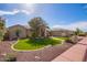 A single-story home with a three-car garage, desert landscaping, and a mature tree in the front yard at 4055 N Recker Rd # 62, Mesa, AZ 85215