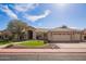 Charming single-story home featuring a desert landscape, mature tree, and a spacious three-car garage at 4055 N Recker Rd # 62, Mesa, AZ 85215