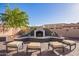This backyard fireplace features a lounge area and desert landscaping at 4055 N Recker Rd # 62, Mesa, AZ 85215