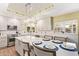 Bright kitchen featuring white cabinets, quartz countertops, stainless steel appliances, and a large island at 4055 N Recker Rd # 62, Mesa, AZ 85215