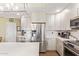 Modern kitchen with white cabinets, stainless steel appliances, quartz countertops, and stylish backsplash at 4055 N Recker Rd # 62, Mesa, AZ 85215