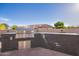 This outdoor kitchen features a stone surround, stainless steel grill, and concrete patio at 4055 N Recker Rd # 62, Mesa, AZ 85215