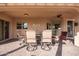 This covered patio features ample seating and sliding glass door access to the interior at 4055 N Recker Rd # 62, Mesa, AZ 85215