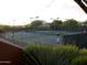 This community tennis court features beautiful desert landscape and is lighted for evening play at 4055 N Recker Rd # 62, Mesa, AZ 85215