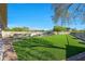 Spacious backyard featuring artificial grass, pool, and shaded lounge areas at 4417 W El Cortez Trl, Phoenix, AZ 85083