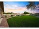 Large backyard with lush artificial turf, pool area, and mature trees at 4417 W El Cortez Trl, Phoenix, AZ 85083