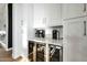 Bar area features custom cabinetry, wine refrigerators, beverage station, and stylish backsplash at 4417 W El Cortez Trl, Phoenix, AZ 85083