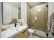 This bathroom features a wood vanity, a glass enclosed shower, and modern fixtures at 4417 W El Cortez Trl, Phoenix, AZ 85083