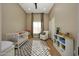 Cozy Bedroom featuring a crib, gray-and-white rug, and comfortable rocking chair at 4417 W El Cortez Trl, Phoenix, AZ 85083